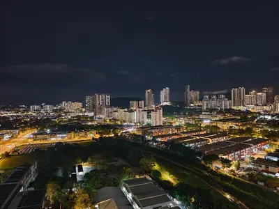 a city skyline at night with tall buildings at Aiman Damia Homestay in Kuala Lumpur