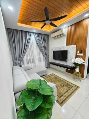 a living room with a couch and a ceiling fan at Aiman Damia Homestay in Kuala Lumpur
