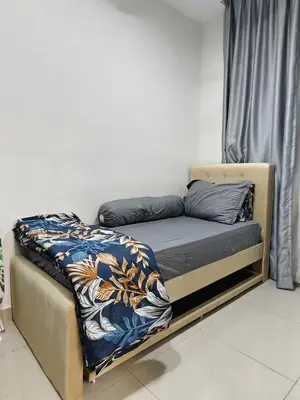 a bed sitting in a room with at AimanDamia Homestay Setapak II in Kuala Lumpur