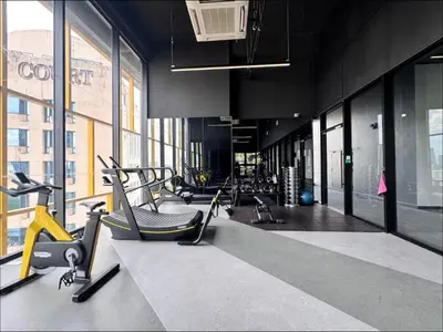 a gym with a bunch of exercise equipment in a building at Opus Residence by Cloud Escape in Kuala Lumpur