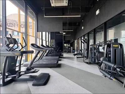 a gym with rows of treadmills and cardio machines at Opus Residence by Cloud Escape in Kuala Lumpur