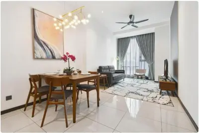 a living room with a dining room table and a couch at Opus Residence by Cloud Escape in Kuala Lumpur