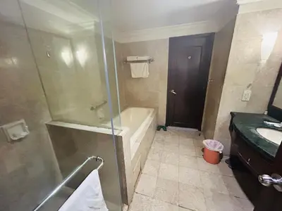 a bathroom with a shower and a tub and a sink at Times square at suite kl in Kuala Lumpur