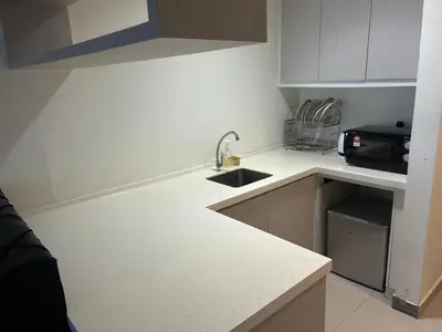a small kitchen with a sink and a microwave at Times square at suite kl in Kuala Lumpur
