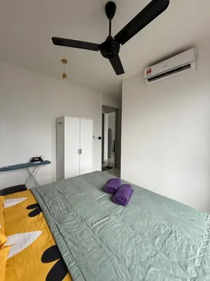 a bedroom with a bed with a ceiling fan at Cozy kenwingston platz kl 2-5pax 2BR&2BR Klcc view with free parkin 4305 in Kuala Lumpur