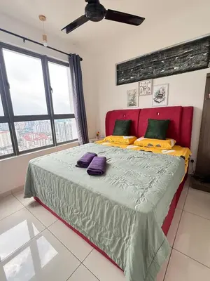 a bedroom with a large bed with a red headboard at Cozy kenwingston platz kl 2-5pax 2BR&2BR Klcc view with free parkin 4305 in Kuala Lumpur