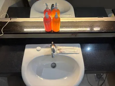 a bathroom with a sink with two bottles on it at SG Residence by Lush Living in Kuala Lumpur