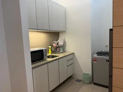 a small kitchen with a sink and a microwave at SG Residence by Lush Living in Kuala Lumpur