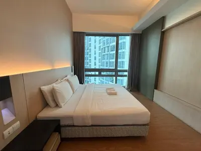 a bedroom with a large bed with a large window at SG Residence by Lush Living in Kuala Lumpur