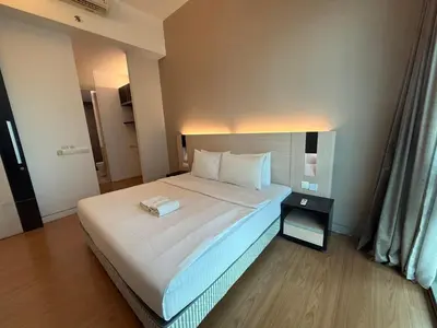 a bedroom with a bed with a book on it at SG Residence by Lush Living in Kuala Lumpur