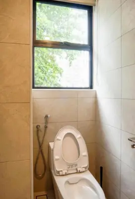 a bathroom with a toilet with a window at 68 Palms 01 l Midvalley l KL Sentral l 5 Pax in Kuala Lumpur