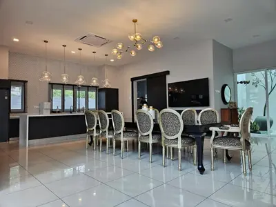 a dining room with a black table and chairs at Villa Homescape, Mont Kiara in Kuala Lumpur