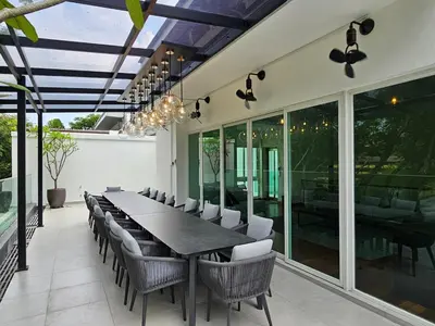 a dining room with a long table and chairs at Villa Homescape, Mont Kiara in Kuala Lumpur