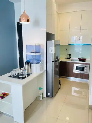 a kitchen with a stainless steel refrigerator and a counter at Lavile Homestay in Kuala Lumpur