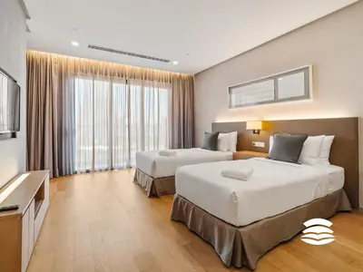 a hotel room with two beds and a television at 188 Suites KLCC by Soulasia in Kuala Lumpur