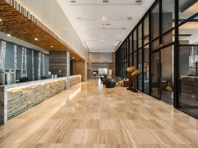 an office lobby with wood floors and glass walls at 188 Suites KLCC by Soulasia in Kuala Lumpur