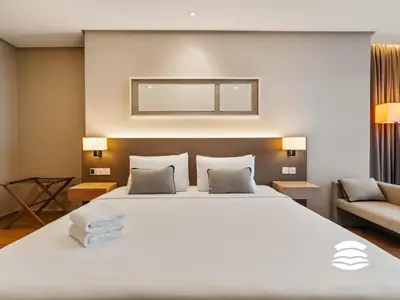 a bedroom with a large white bed and a couch at 188 Suites KLCC by Soulasia in Kuala Lumpur