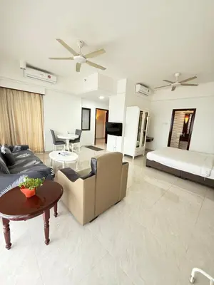 a living room with a couch and a table at Times Residence At BTS Kuala Lumpur in Kuala Lumpur