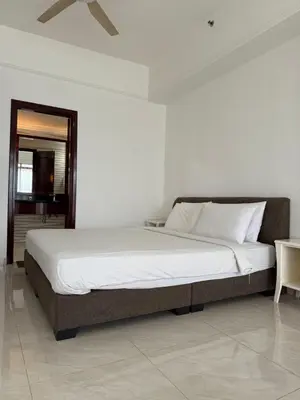 a large bed in a bedroom with a table at Times Residence At BTS Kuala Lumpur in Kuala Lumpur