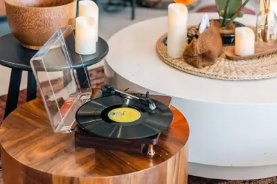 a record player on a wooden table with candles at Flame of the Forest Retreat 38Pax 8R7B Pool Villa Kuala Lumpur in Kuala Lumpur