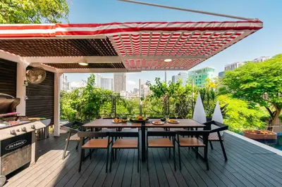 a patio with a table and chairs and a grill at Flame of the Forest Retreat 38Pax 8R7B Pool Villa Kuala Lumpur in Kuala Lumpur