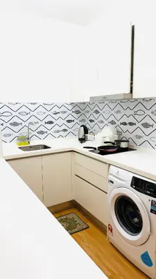 a kitchen with a washing machine and a sink at Chambers Serviced Suites Kuala Lumpur in Kuala Lumpur