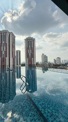 a swimming pool with a view of a city at Chambers Serviced Suites Kuala Lumpur in Kuala Lumpur