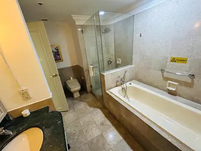 a bathroom with a shower and a tub and a toilet at Times Square by Perfect in Kuala Lumpur