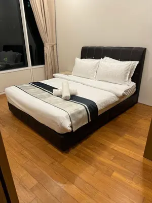 a bed with two pillows on it in a room at Vortex Suites klcc City Malaysia in Kuala Lumpur