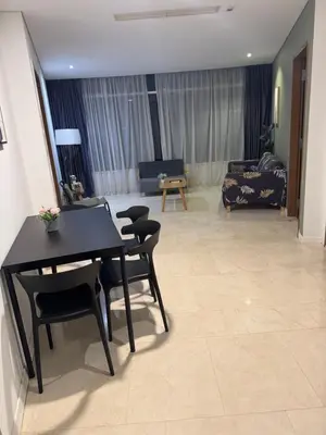 a living room with a table and chairs and a couch at Vortex Suites klcc City Malaysia in Kuala Lumpur