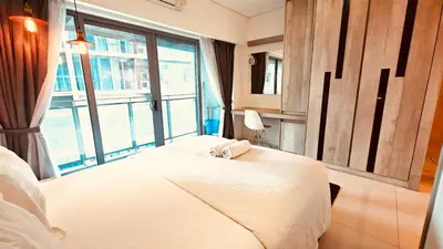 a bedroom with a bed and a large window at Summer Hotel and Condo Suites Nearby KLCC Area in Kuala Lumpur