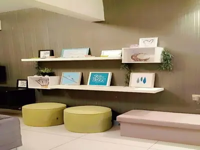 a room with two stools and shelves with pictures at PV21 Luxe Comfort 3 Bedroom Modern Homestay in Prime Location near Setapak Central Mall in Kuala Lumpur