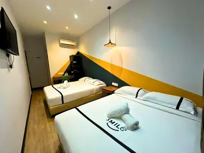 a hotel room with two beds and a television at Seeds Hotel Bukit Bintang in Kuala Lumpur
