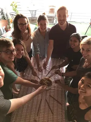 a group of people standing around a table at The Ohana Suite in Kuala Lumpur