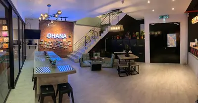 a restaurant with a table and chairs and a staircase at The Ohana Suite in Kuala Lumpur