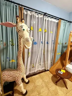 a stuffed giraffe in a room with a curtain at Bintang Nyonya Villa-A self designed Home in Kuala Lumpur