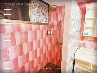 a pink bathroom with a shower and a sink at Bintang Nyonya Villa-A self designed Home in Kuala Lumpur