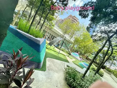 a park with a playground with an umbrella and a swing at Robertson Residence Main City Kuala Lumpur in Kuala Lumpur