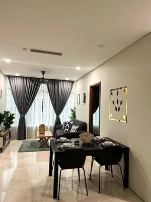 a living room with a table and a couch at Modern Condo Next To Petronas Towers in Kuala Lumpur