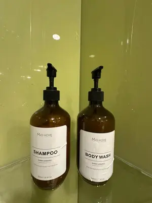 two bottles of soap sitting on a shelf at Modern Condo Next To Petronas Towers in Kuala Lumpur