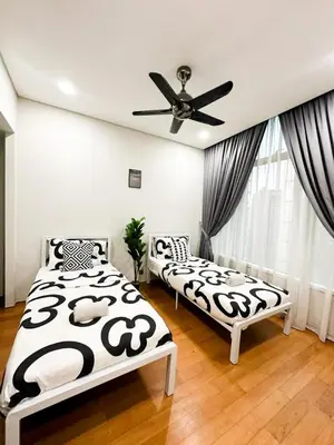 a bedroom with two beds and a ceiling fan at Modern Condo Next To Petronas Towers in Kuala Lumpur