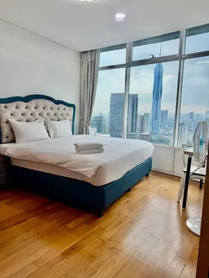 a bedroom with a large bed with a large window at Vortex Premium Apartment klcc in Kuala Lumpur