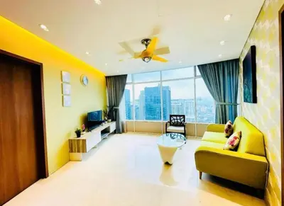 a living room with a yellow couch and a large window at Vortex Premium Apartment klcc in Kuala Lumpur
