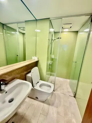 a bathroom with a toilet and a sink and a shower at Vortex Premium Apartment klcc in Kuala Lumpur