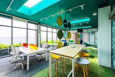 an office with tables and chairs and windows at Riveria City KL Sentral by Nest Suite in Kuala Lumpur