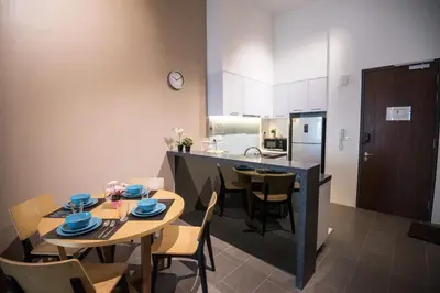 a kitchen and dining room with a table and chairs at Bangsar LRT Suites EST by LSA in Kuala Lumpur