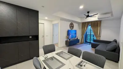 a living room with a dining table and a tv at The Thant Suite in Kuala Lumpur
