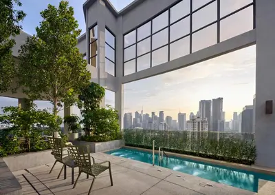 a view of the city from the balcony of a building at The Thant Suite in Kuala Lumpur