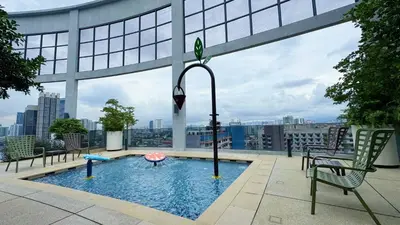 a swimming pool on the roof of a building at The Thant Suite in Kuala Lumpur
