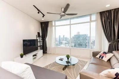 a living room with a couch and a large window at Vortex KLCC by LSA in Kuala Lumpur